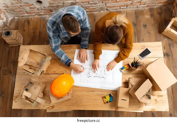 Two People Working on Architectural Plans