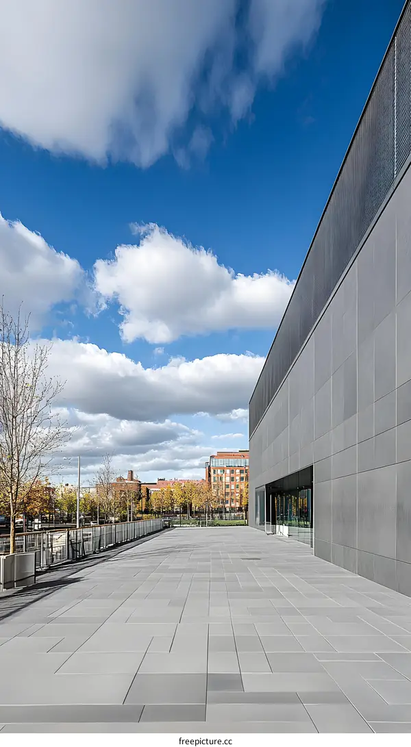Modern Building Exterior with Grey Facade and Pavement