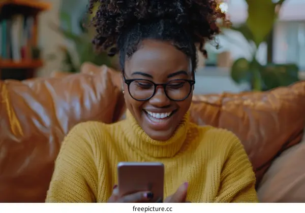 Black woman smiling while texting on her phone