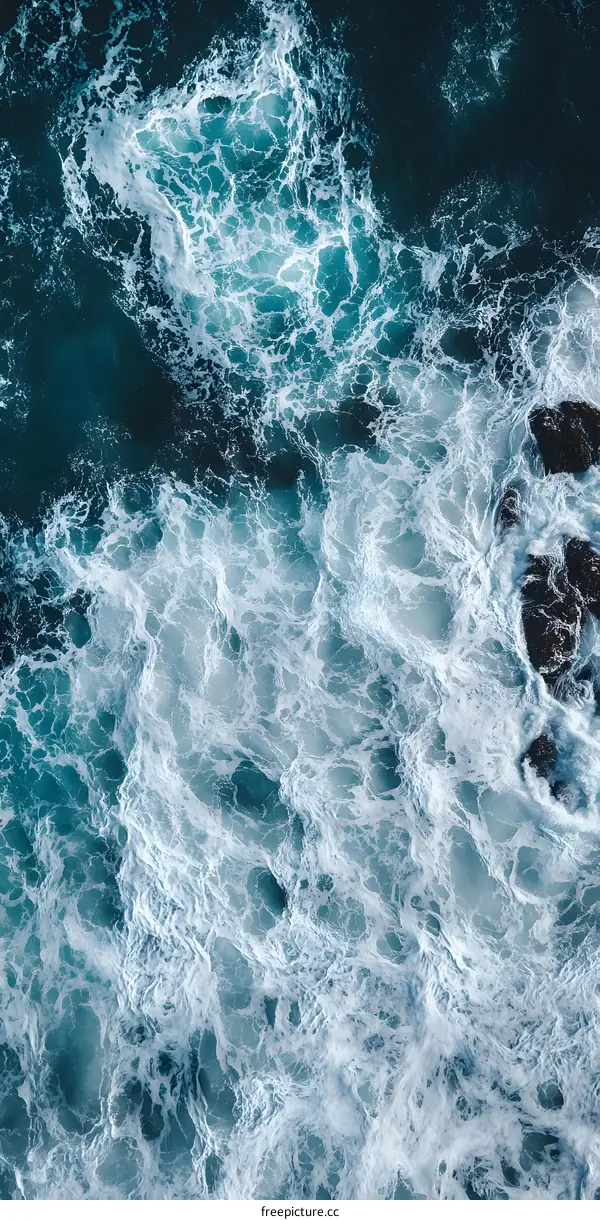 Aerial View of Ocean Waves with White Foam