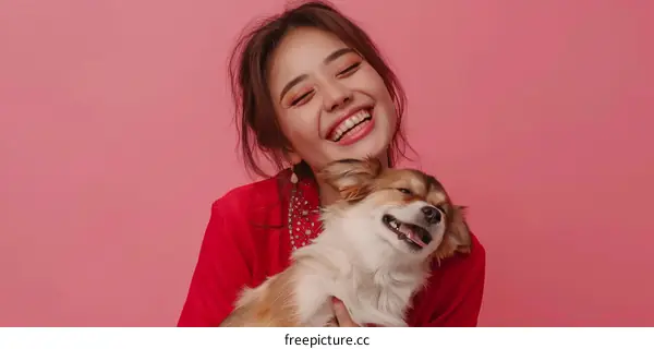Asian woman hugging small dog