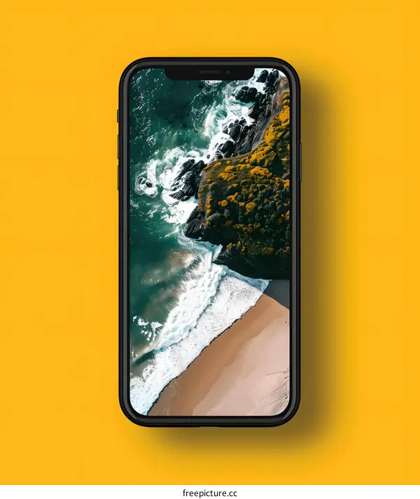 Smartphone Display With Coastline and Ocean Wallpaper