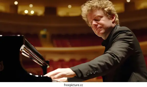 Pianist Performing on Stage in Concert Hall
