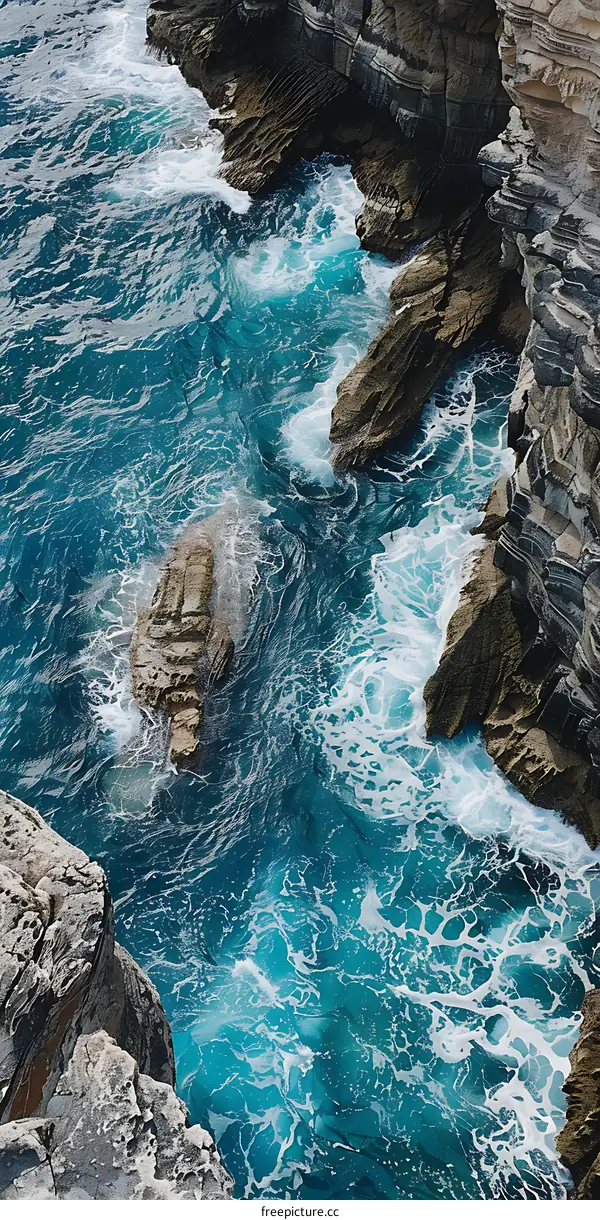 Aerial View of Ocean Water Crashing Against Rocks
