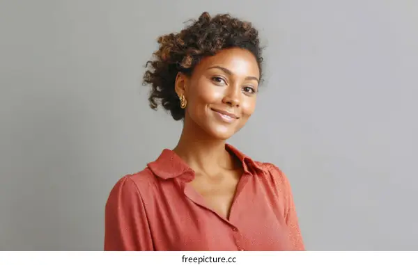Portrait of a Smiling African Woman in a Coral Top