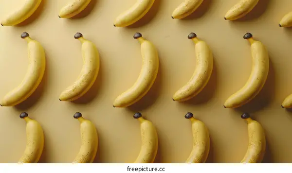 Bananas arranged in a grid pattern on a yellow background