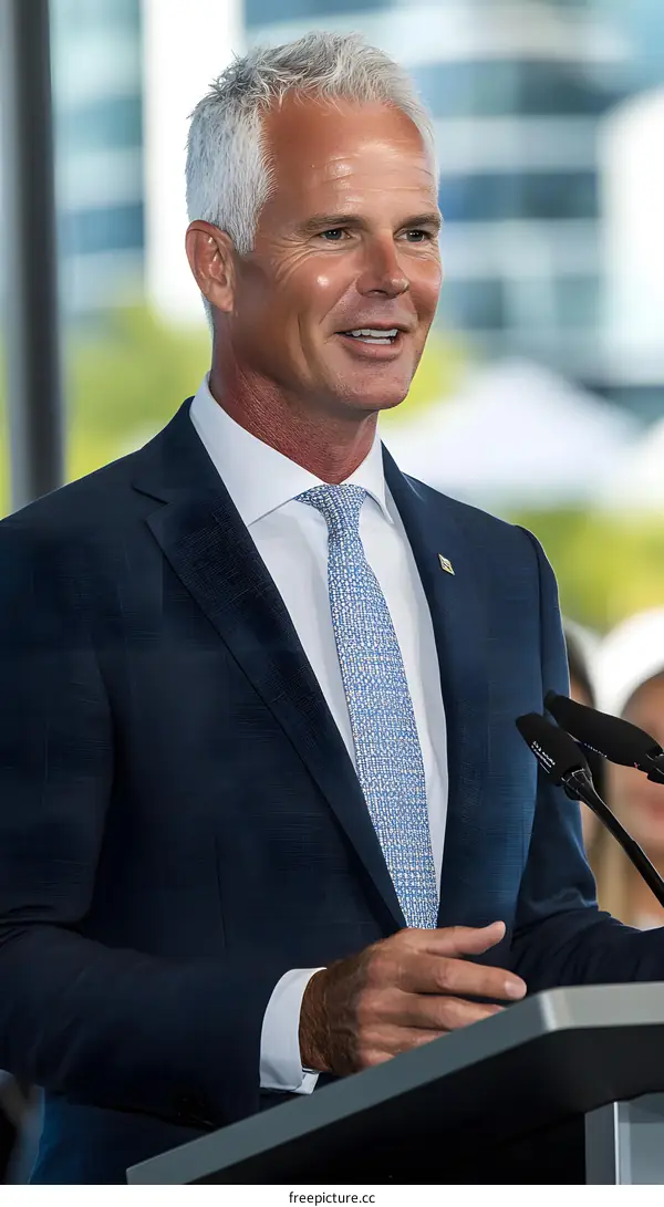 Portrait of Man in a Suit Speaking at a Podium