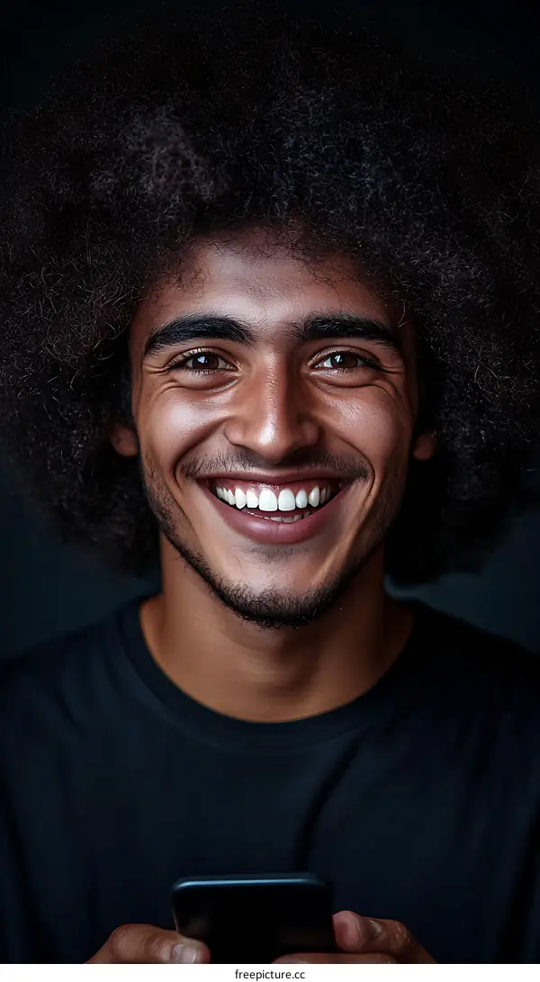 Smiling African Man Holding Mobile Phone