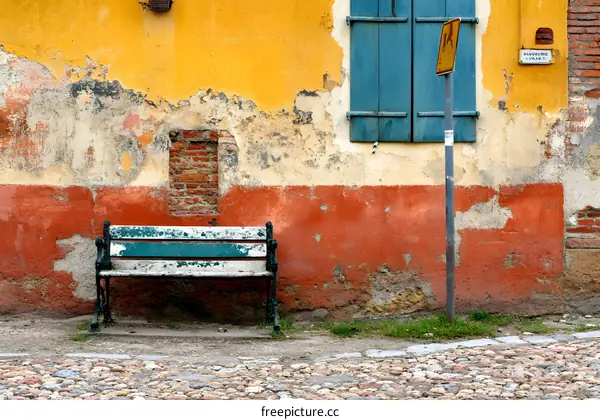 Old Rustic Bench Against a Colorful Wall
