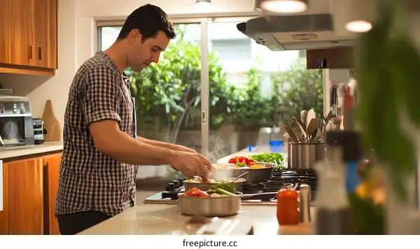 Man Cooking in Kitchen with Large Window