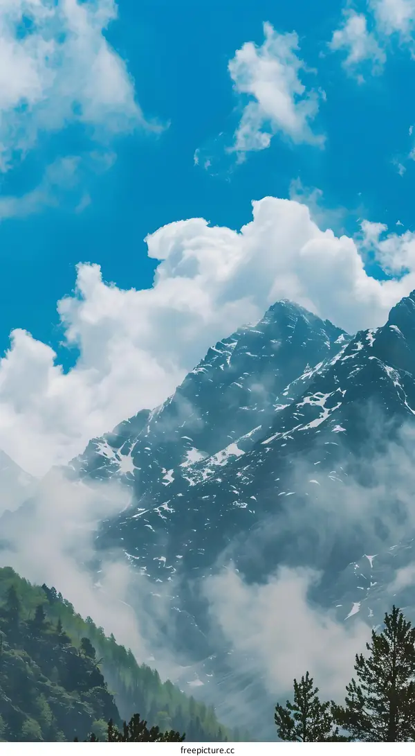 Mountain Range Covered in Fog Under a Blue Sky