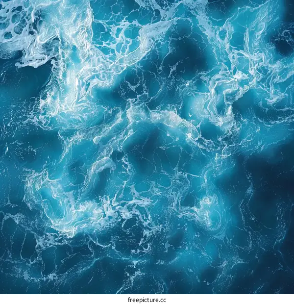 Deep blue ocean water surface with white foam