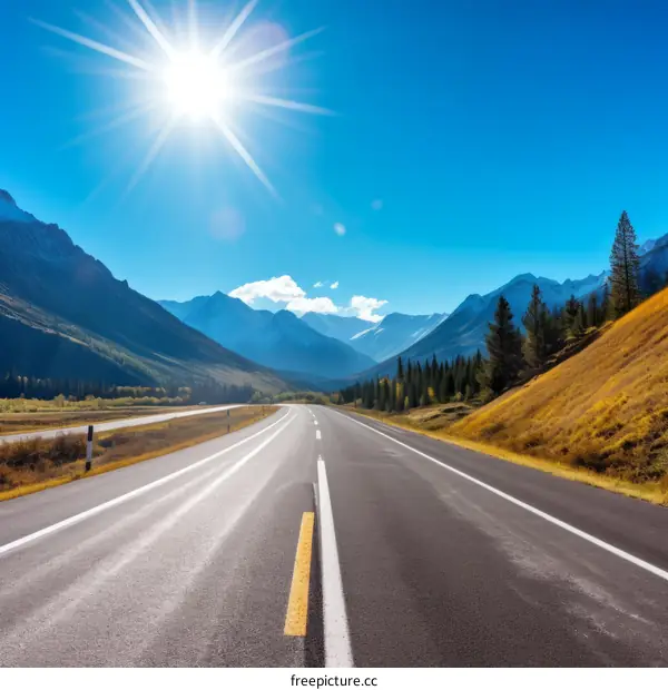 Road through the mountains with beautiful blue sky and bright sun