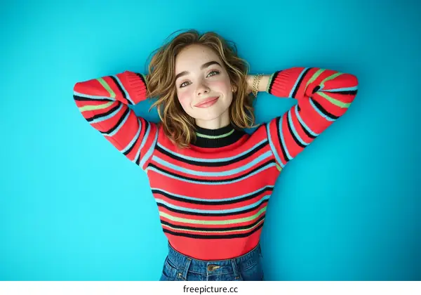 Young Woman Relaxing in Colorful Striped Sweater