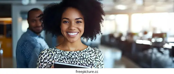 Smiling African American Businesswoman Using Tablet In Office