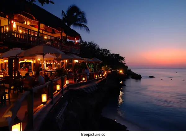 Tourists enjoying the sunset at a beach resort