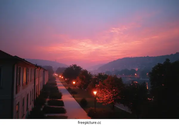 Serene Pink Sunrise Over Cityscape with Buildings