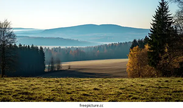 Autumnal Landscape with Misty Mountains