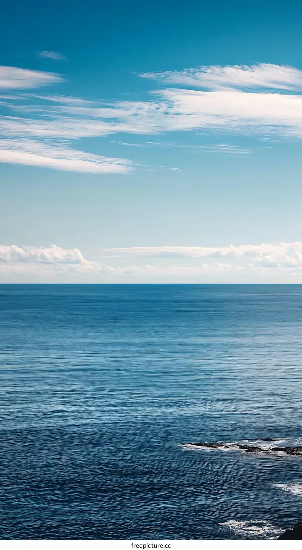 Blue Ocean and Sky with White Clouds