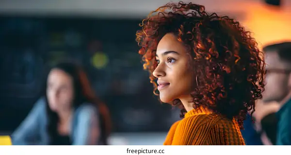 Young Woman with Curly Hair Thinking and Looking Away