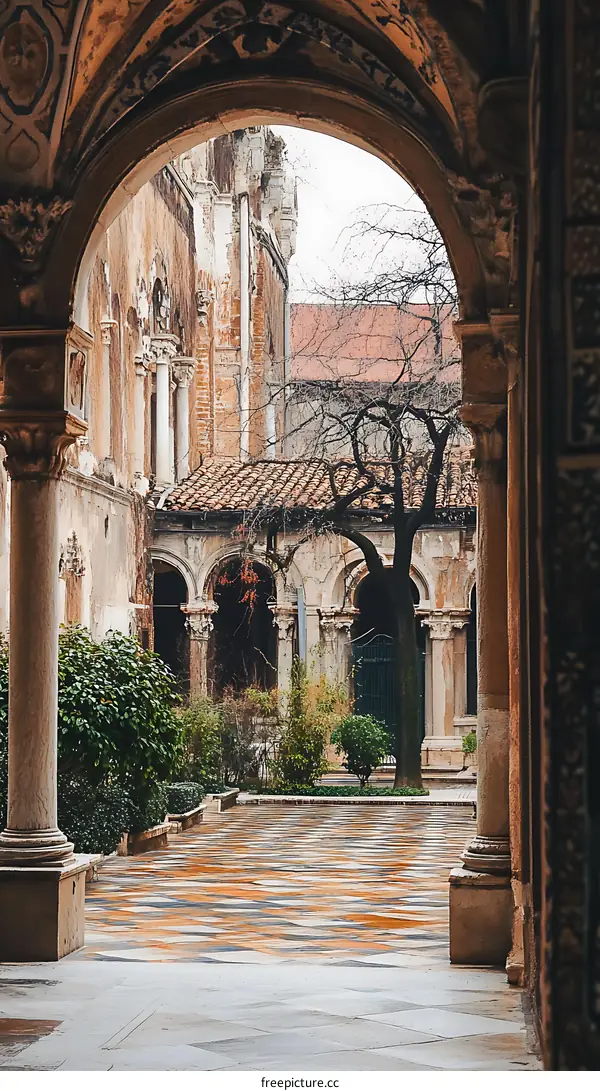 Archway Leading to Courtyard with Stone Columns and Greenery