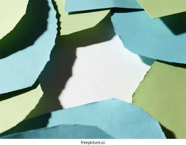 Close-up of colorful torn paper with soft shadows and varying edges