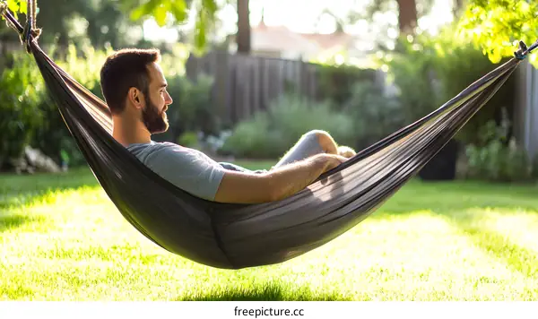 Man Relaxing in Hammock in Backyard