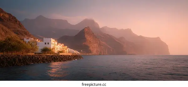 Coastal Town at Sunset with Dramatic Mountains