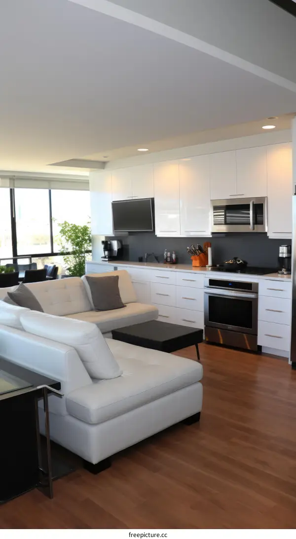 Spacious Open-Concept Living Room with White Sectional Sofa and Modern Kitchen