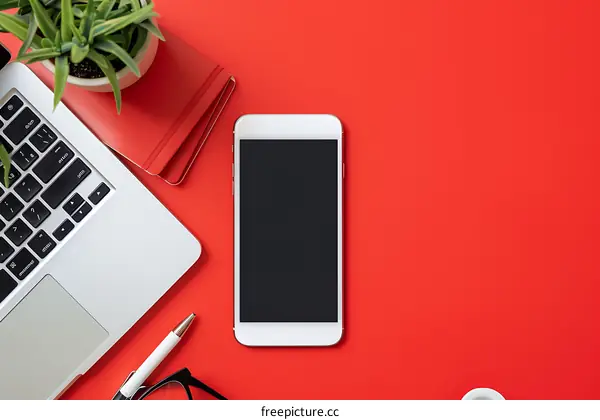 Red Desk Flat Lay with Laptop, Phone, and Notebook