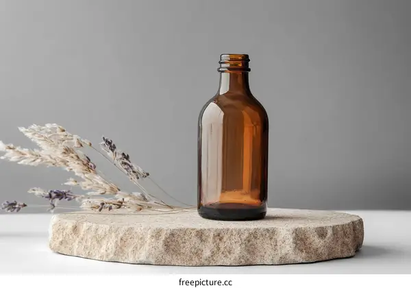 Amber Glass Bottle on Stone Pedestal with Dried Flowers