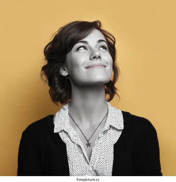 Woman Smiling Upward on a Mustard Background
