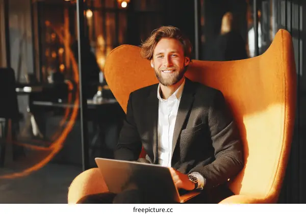Businessman Working on Laptop in Modern Office