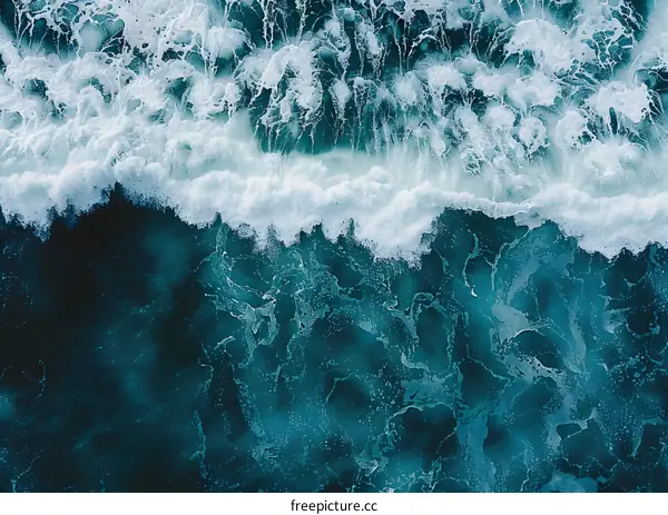 Aerial View of Ocean Waves Breaking