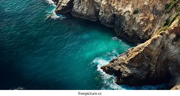 Aerial View of Turquoise Water Surrounded by Rocky Cliffs