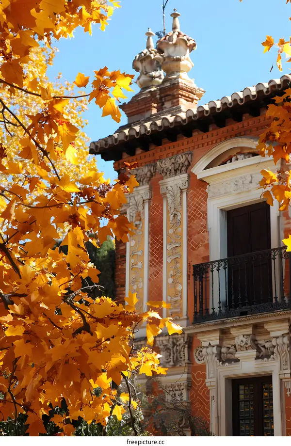 European style architecture with bright orange fall leaves in the foreground