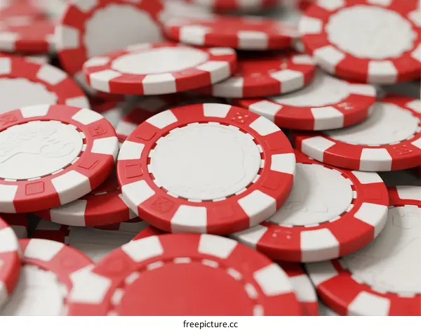 A collection of red and white poker chips arranged in a pile