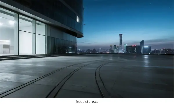 Modern city building with empty road at twilight