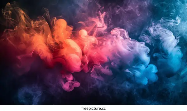 Colorful smoke flowing on a dark background