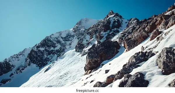 Snowy Mountain Peak with Clear Blue Sky