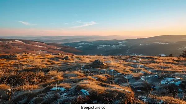 Scenic Mountain View At Sunset With Grass And Snow