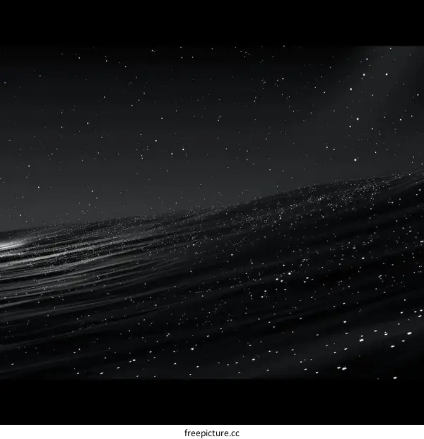 Black and white image of a starry night sky with a calm sea