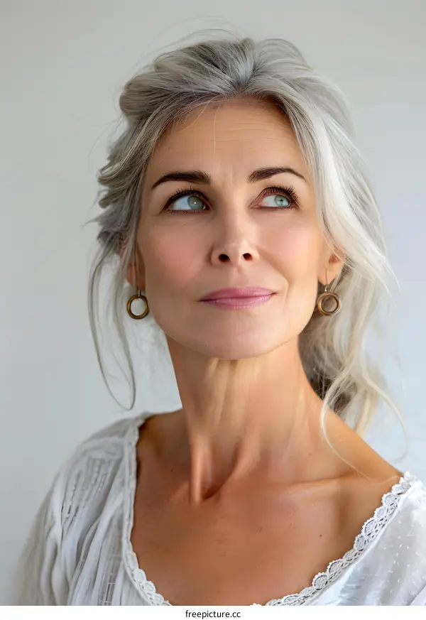portrait of a beautiful caucasian woman with gray hair looking up