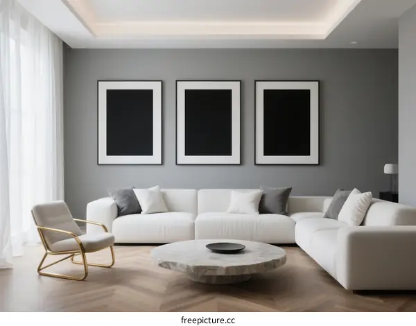 Modern living room with white sofa and three black framed pictures on gray wall
