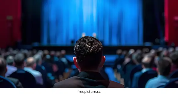 Audience Member Looking at Stage During Presentation