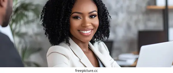 Smiling African American Businesswoman Sitting at a Desk
