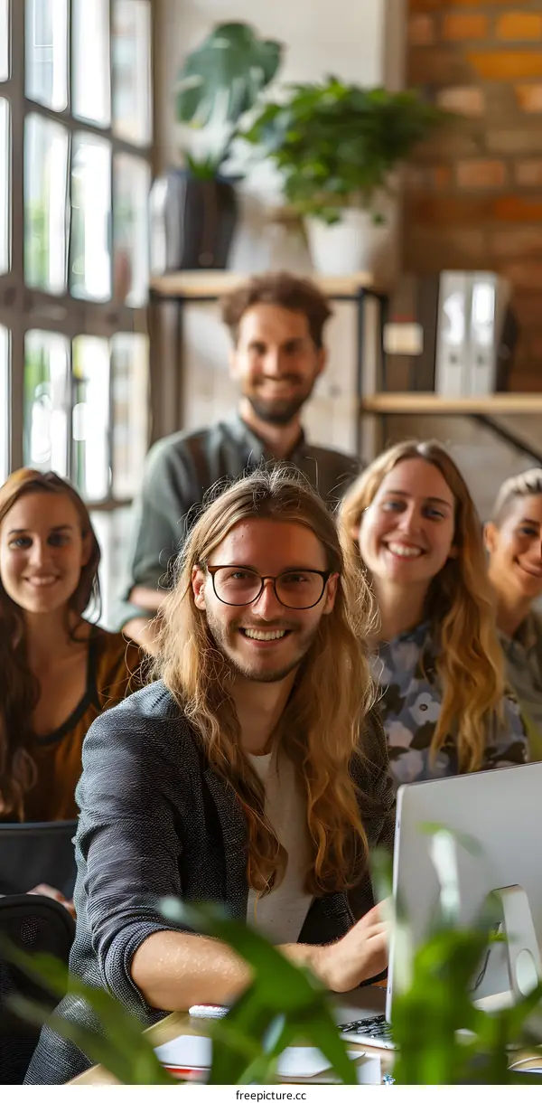 portrait of a group of young professionals in a modern office smiling at the camera