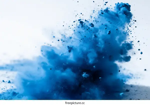 Vibrant Blue Powder Explosion in Mid-Air Capturing Dynamic Moment