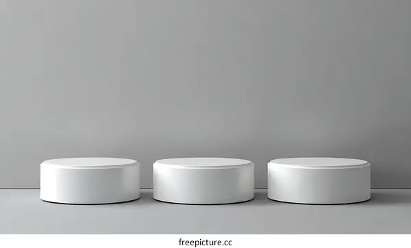 Three White Cylindrical Podiums on a Gray Background