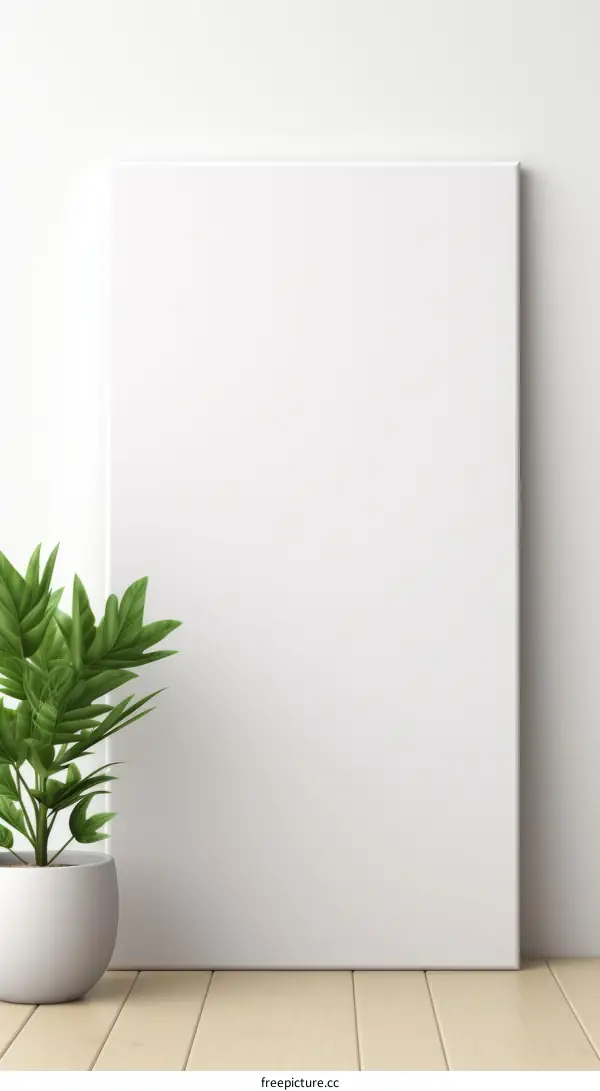 A blank canvas stands on the wooden floor next to a potted plant